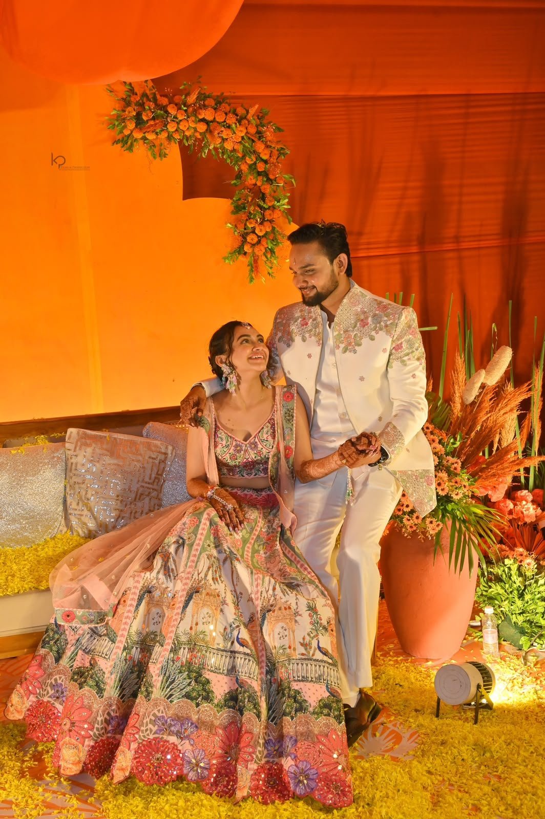 Couple portrait at a marigold-styled mehndi celebration