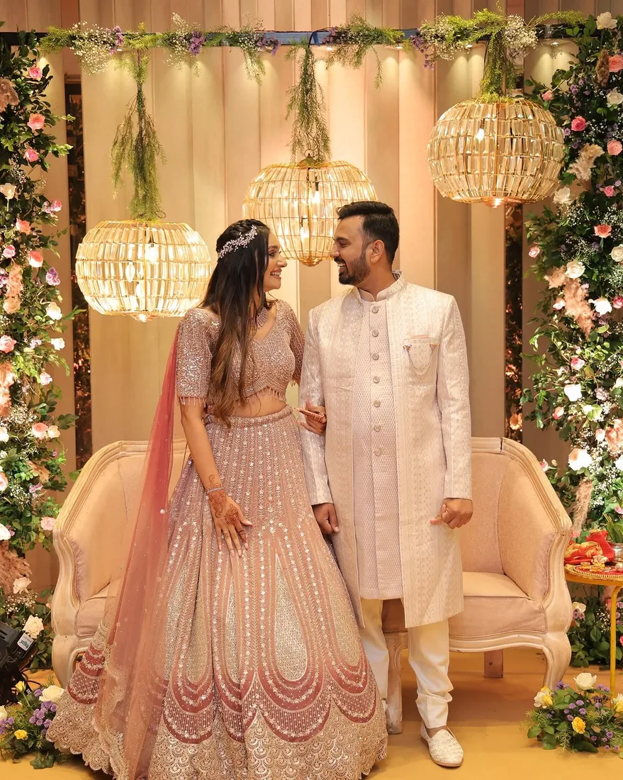 Wedding couple at a styled floral arch