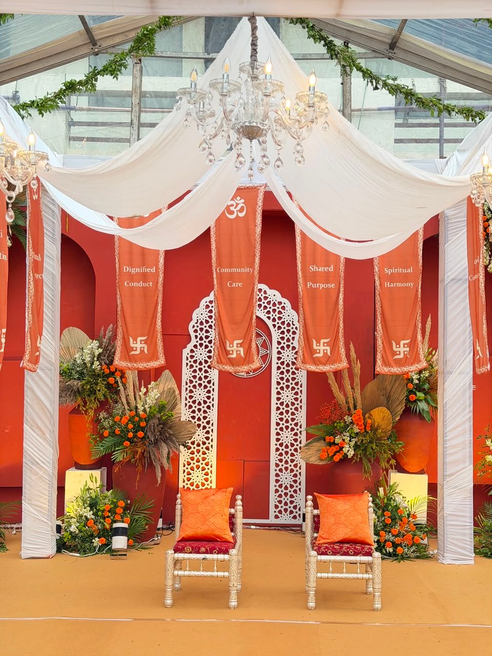 Close-up of mandap seating with jaali backdrop and dried palm florals
