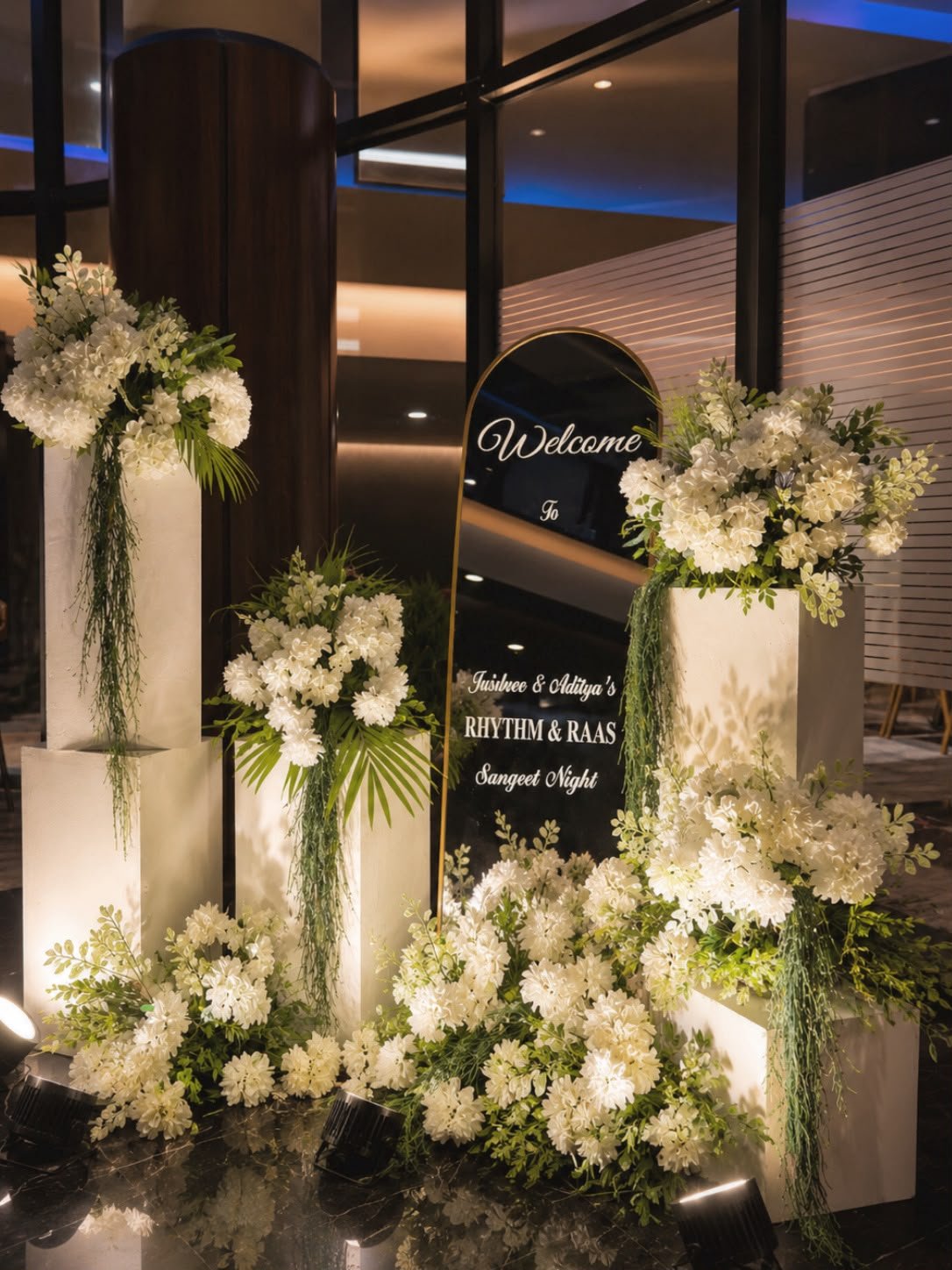 White floral welcome signage for a sangeet night entrance